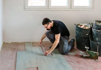 Bricklayer measuring tiles to install a floor Bricklayer measuring tiles to install a floor